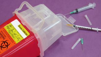 Sharps container with needles